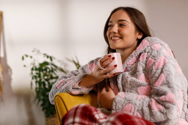 istock Enjoying the first morning coffee in a cozy bathrobe 2002525367