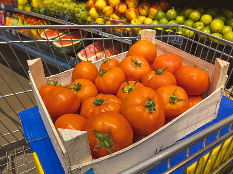 fresh tomatoes in wooden crate delivered to supermarket