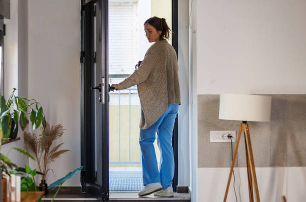 istock Young nurse exiting her front door when leaving for work in the morning 2002543730