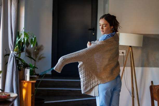istock Nurse putting on a cardigan, getting ready to leave for work 2002543733