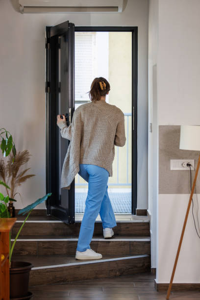 istock Young nurse exiting her front door when leaving for work in the morning 2002543736