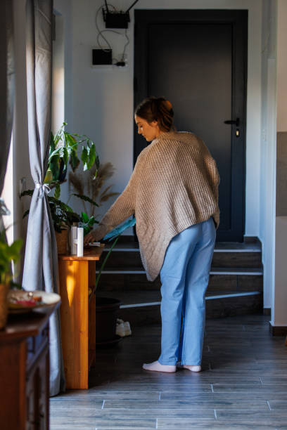 nurse putting on her id card before heading out to work - nurse reaching women doctor - fotografias e filmes do acervo