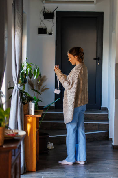 istock Nurse putting on her ID card before heading out to work 2002543747