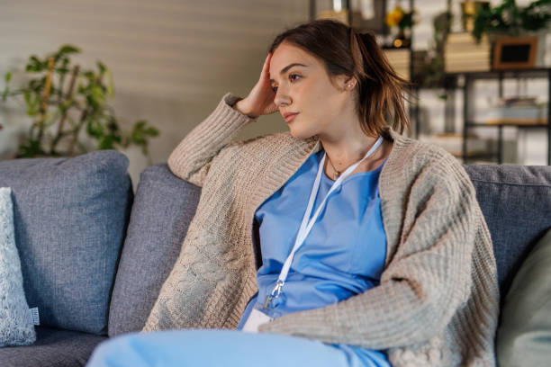 istock Tired nurse simply sitting on the sofa and resting after coming home from work 2002549797