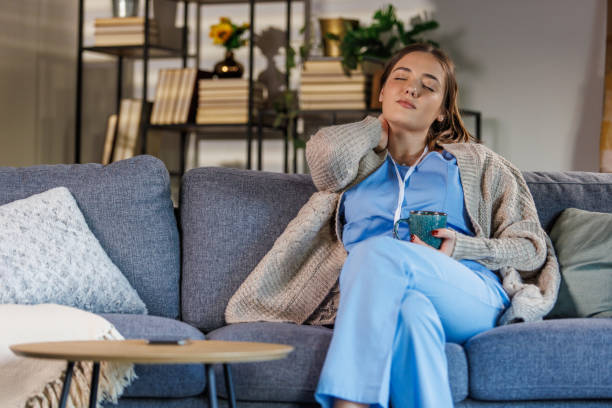 istock Tired nurse simply sitting on the sofa and resting after coming home from work 2002549800