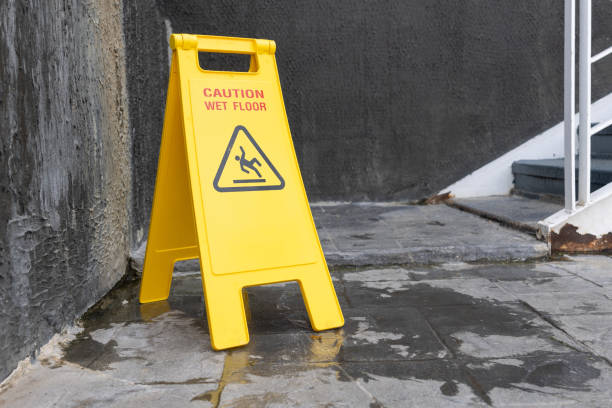 istock wet floor sign with water drops on wet stone floor. 2002557187