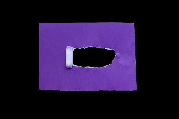 istock Ripped purple paper isolated on black background 2002576743