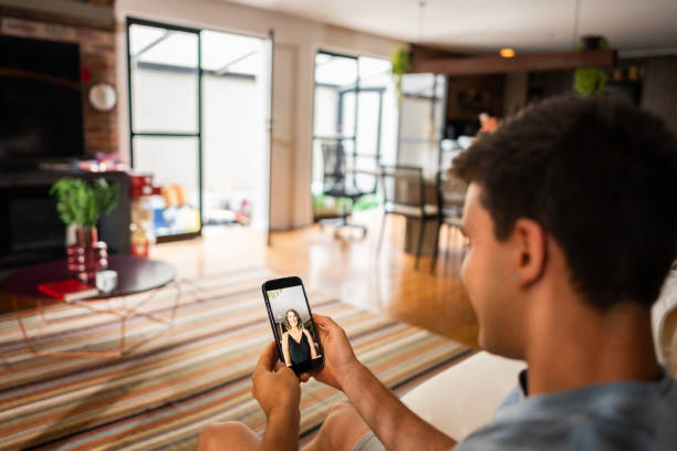 istock Young man taking to his mother on a video call using mobile phone at home 2002585169