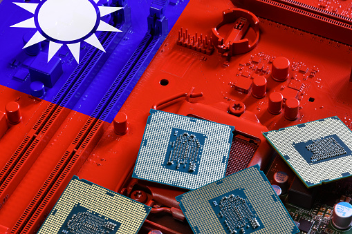 Flag of Taiwan on a red painted PC motherboard with some processors on it. Concept for supremacy in global microchip and semiconductor manufacturing. Italy