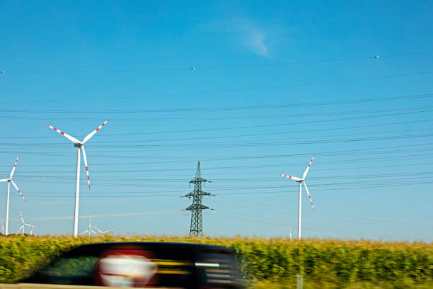 wind power station along the highway during the day. Saving electricity