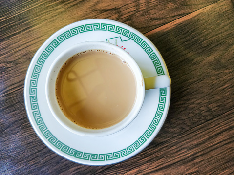 Top view of a cup of tea on wooden table closeup