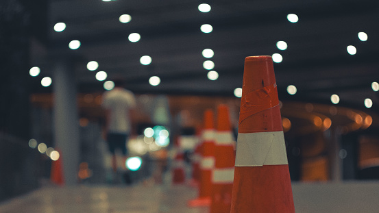 Traffic cone, perspective, bokeh, parking, man. High quality photo