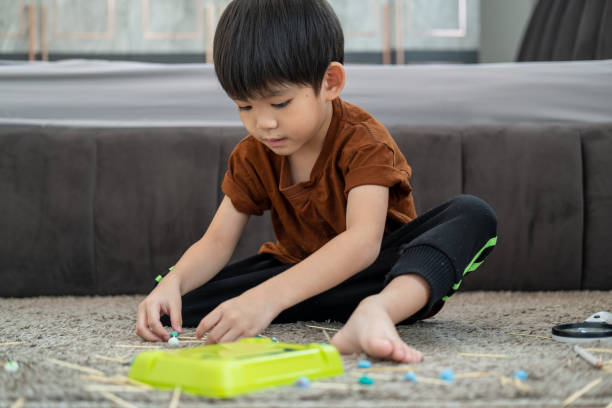 istock Asian boy playing with plasticine in the room 2002685439