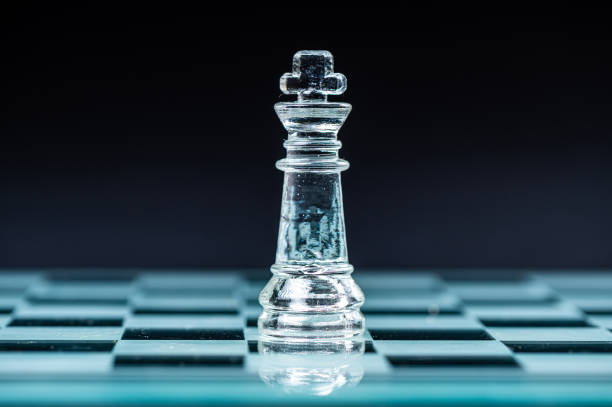 istock glass chess board game in black background ,selective focus on King, leadership concept 2002689540