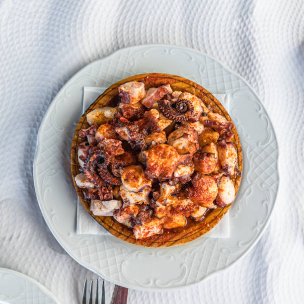 istock Galician-style octopus dish, served on its typical wooden plate 2002727968