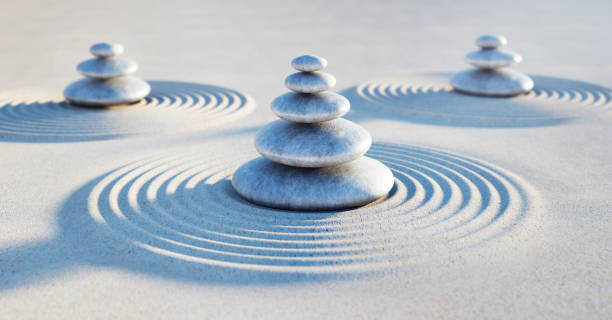 istock Three stacks of pebbles in the evening sun - Zen garden 2002745416
