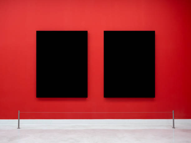 Mockup two blank space in black vertical square artist painting frames, isolated on red background. Empty 2 photo frames hanging on red wall behind display stanchions on white floor in museum.