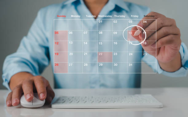 istock Businessman marking dates on virtual calendar, managing his business schedule, setting reminders for important appointments, creative collage for planning ideas, appointment scheduler 2002778703