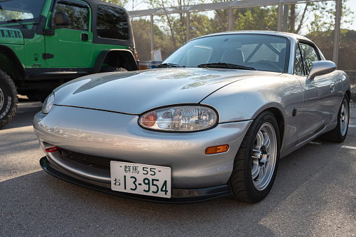 Montmelo, Spain – October 20, 2023: Front view of a nice gray Japanese light sports car, the Mazda Miata MX-5 NB, parked in the street.