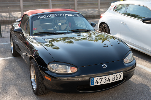 Montmelo, Spain – October 20, 2023: Front view of a black Japanese two-seater sports car, Mazda MX-5 Miata NB