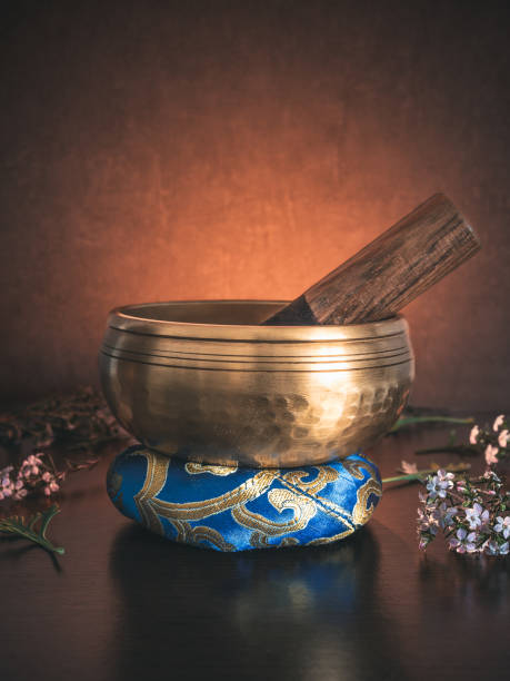 istock Tibetan singing bowl on ring cushion with golden light in the background 2002832996