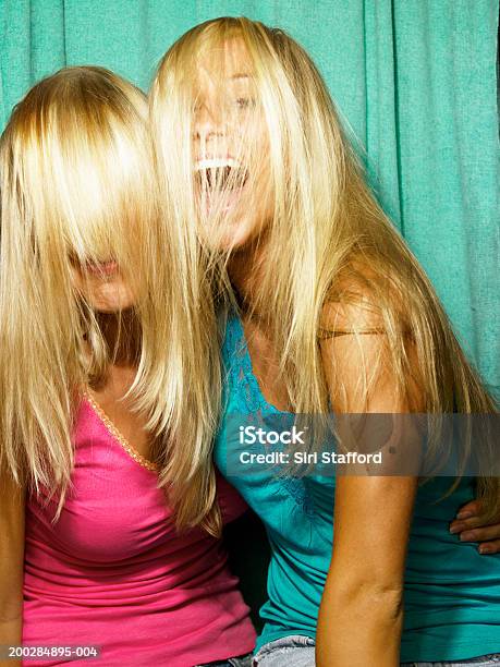 Young Women Playing Around In Photo Booth Stock Photo - Download Image Now - Photo Booth, Friendship, Two People