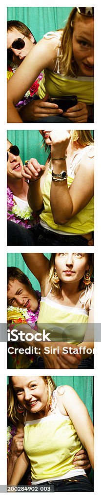 Young couple playing around in photo booth  Photo Booth Stock Photo