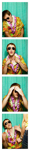 young man wearing hawaiian shirt and leis in photo booth - fotoautomat fotky - stock snímky, obrázky a fotky
