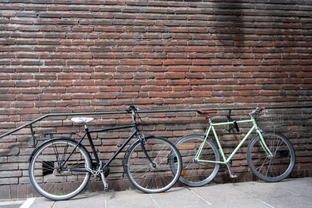 istock Bicycle locked and parked at empty brick wall building railing background. Copy space, ad template 2002849703