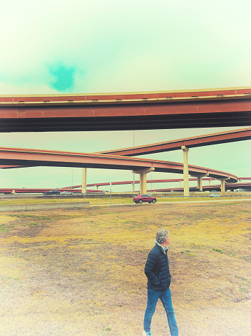 Lone Man Walking Near Highway Overpasses. Shot in Dallas, TX.