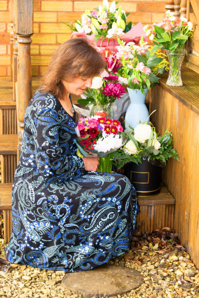 Reflecting amongst the flowers. A great teacher lasts a generation. Nowadays, those that do, also often continue with part time work, after acquisition. teacher retirement party stock pictures, royalty-free photos & images