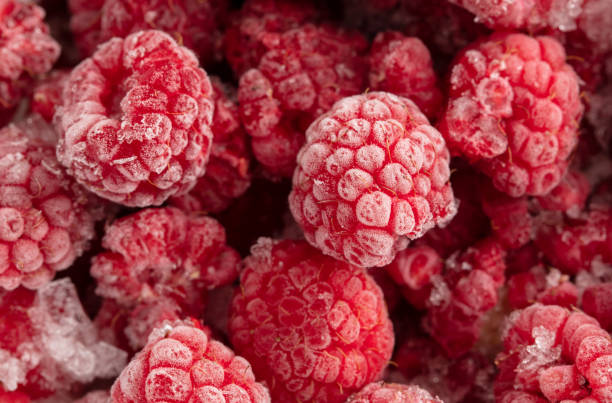 istock Frozen raspberries and blackberries close-up macro photography 2002878635