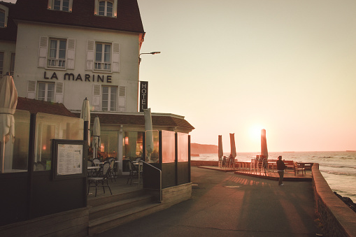 Arromanches les Bains, France – June 04, 2023: A scenic view of a road near the ocean in Arromanches-les-Bains, Normandy, France at sunset