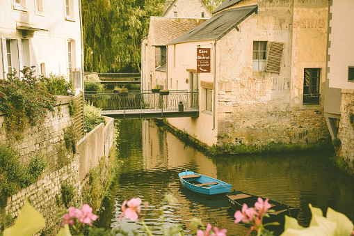 Bayeux, France – June 05, 2023: A scenic view of a boat in a canal in the historical town of Bayeux in Normandy, France