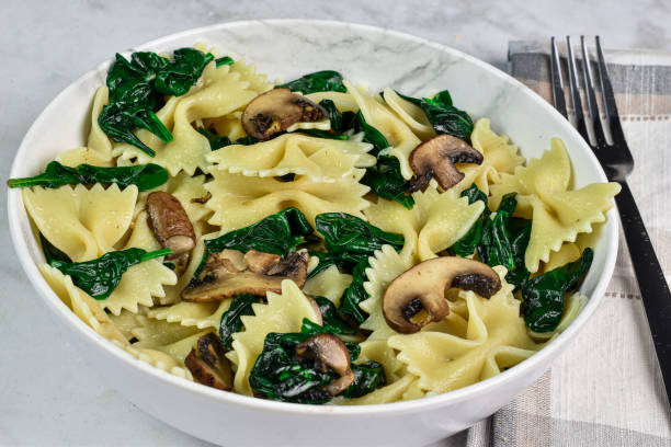 istock farfalle pasta  with spinach and mushrooms 2002915140