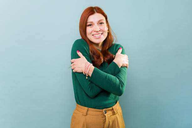 istock Redhead woman smiling embracing self-love 2002935644