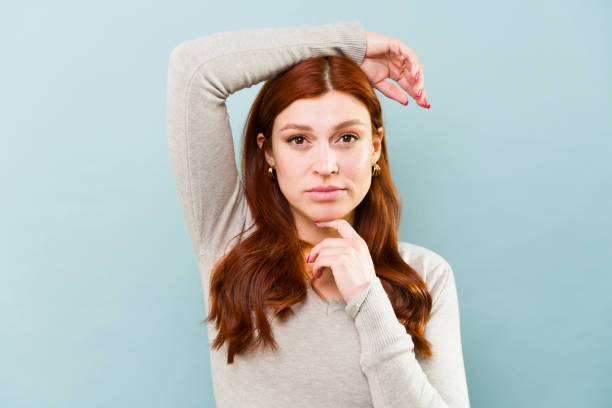 istock Redhead beautiful woman in her 30s in a blue studio background 2002941247