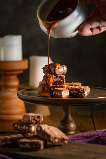 istock Pouring melted chocolate over brownies. 2002971978