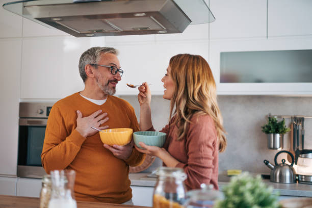 istock Husband and wife prepare breakfast together. 2002989953