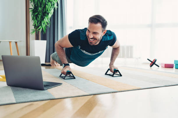 istock Sportsman making with push-ups watching an online training class 2002998949