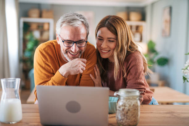 istock Mature happy couple having breakfast together at home and talking. 2003028233