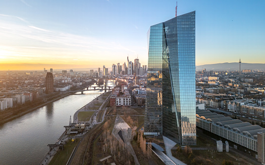 Frankfurt am Main, Germany – January 28, 2024: Aerial view of a river flowing amidst a cityscape with towering buildings