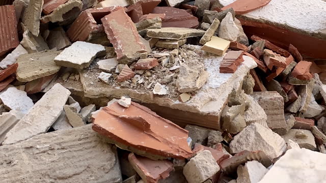 Broken bricks and rubble inside garbage container