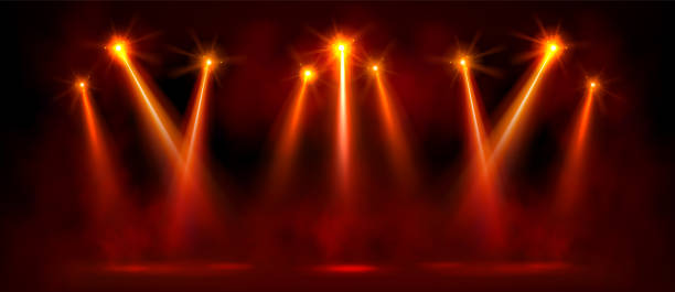 красный яркий прожектор на сцене с эффектом свечения. - black background studio shot horizontal close up stock illustrations