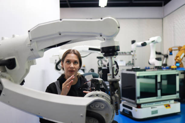 istock Factory Female Industrial Engineer working with automation robot arms machine in intelligent factory industrial on real-time monitoring system software.Digital future manufacture. 2003074267
