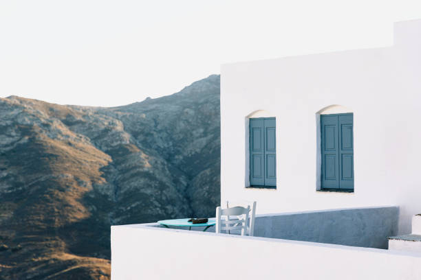 Cycladic blue table with two chairs on a balcony on Serifos island, Cyclades, Greece at sunset
