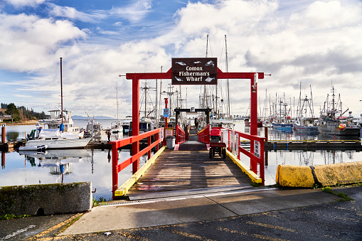 Comox, Canada – November 22, 2023: Looking down the dock at Comox Fisherman's Wharf  from the parking lot.