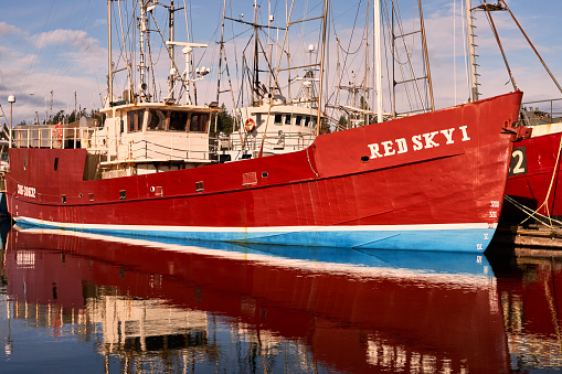Comox, Canada – December 02, 2023: The vessel Red Sky ! docked at the Comox Fisherman's Wharf on a bright sunny day.