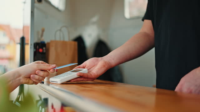 Close-Up of Coffee Truck Owner Hands Out Payment Terminal for Customer to Tap and Pay by Credit Card