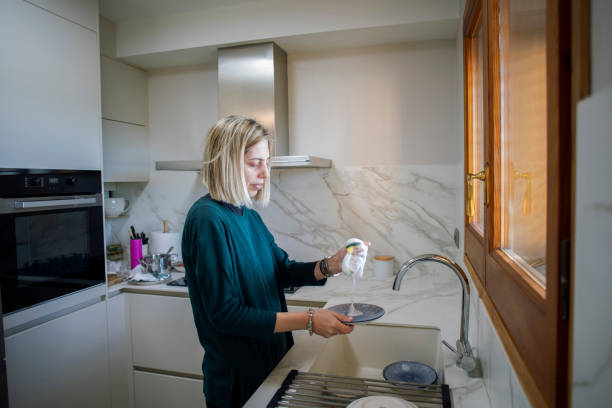 istock Woman cleaning the kitchen at home 2003119827
